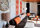 Designer Angel Roberts used a variety of methods, including can lights, lamps, and windows to banish any possible “basement feeling.”