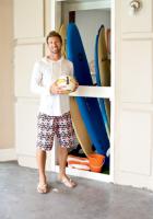 Adam once stored his surfboards on the living room floor, but now has a tidy, dedicated space to store the valuable boards. Below, the pool table fits perfectly in a corner of the living space.                                                                                                                                      