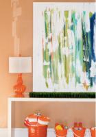Adam says he was once an aspiring architect and has always appreciated the “clean, modern, and slick looks” prevalent in California dwellings. Angel followed his taste and included simple lines and neutral colors- punching them up with splashes of warm reds and oranges.    