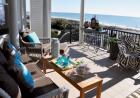 Beach Scene:
The back porch sings in chocolate-covered vinyl wicker to handle seaside weather and plastic chairs covered in zingy zebra print.                         